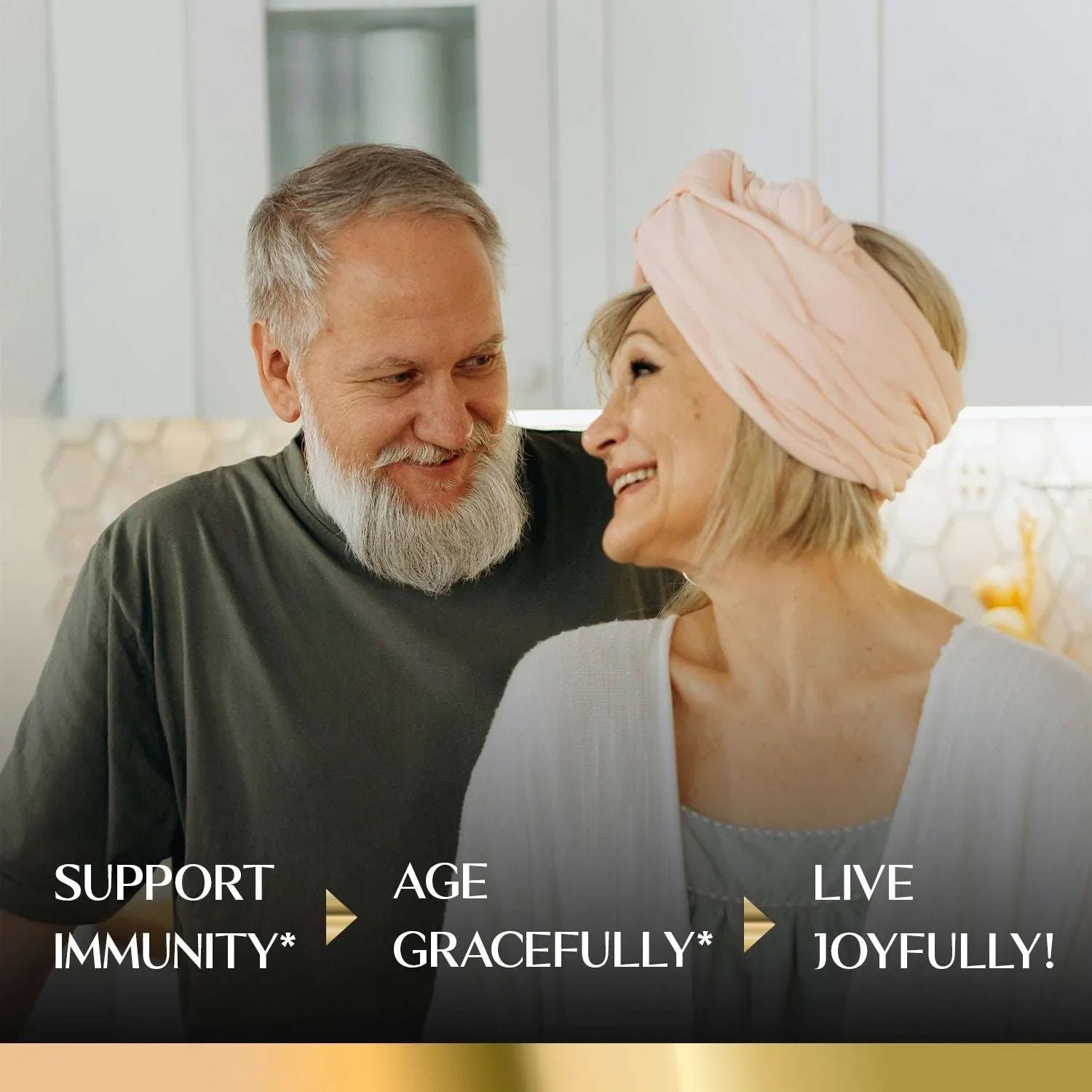 Happy older couple smiling in a kitchen, promoting immune support and healthy aging.